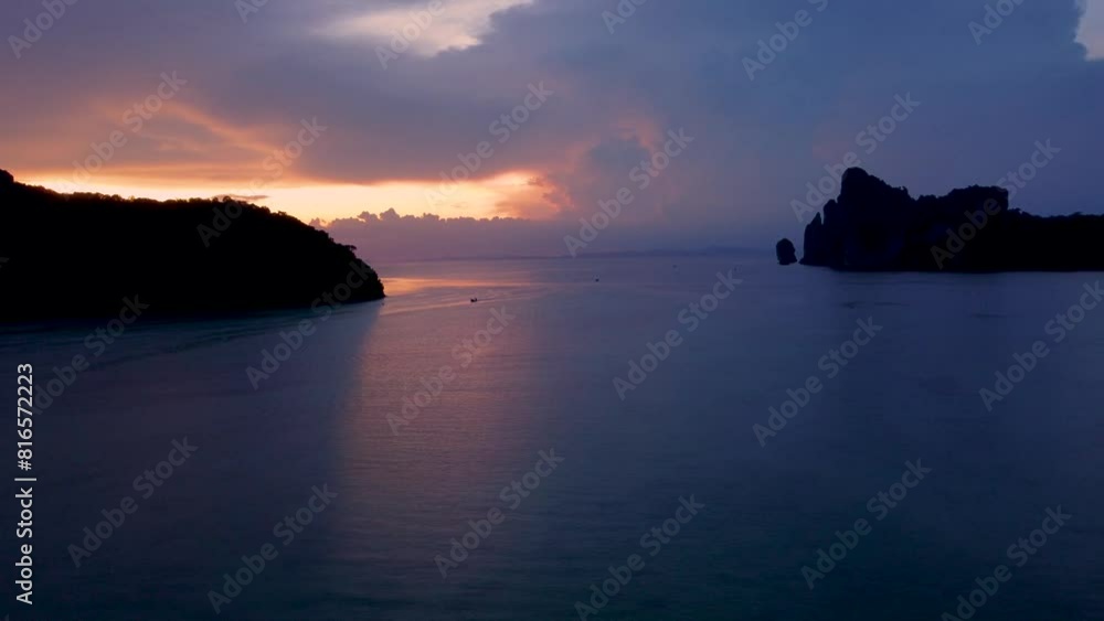 Tropical Storm Brewing: Lighting and Thunder Flashing In the Clouds on Horizon. Bay View From Beach at Ko Phi Phi Island -Krabi, Thailand. Beautiful Evening Sunset. Tropical Storm Brewing: Lighting and Thunder Flashing In the Clouds on Horizon. Bay View From Beach at Ko Phi Phi Island -Krabi, Thailand. Beautiful Evening Sunset.