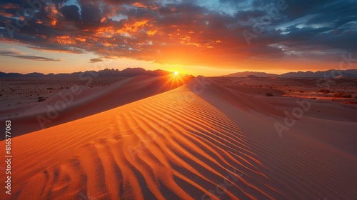 Stunning Sunset Over Vast Desert Landscape with Illuminated Sand Dunes and Dramatic Sky