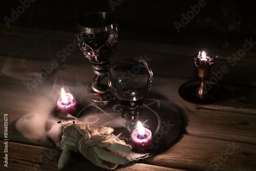 Mysterious Occult Ritual Setup with Crystal Ball and Candles. photo