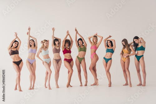 Full length photo no filter of lovely young ladies celebrate high self esteem wear colorful lingerie natural day light studio background