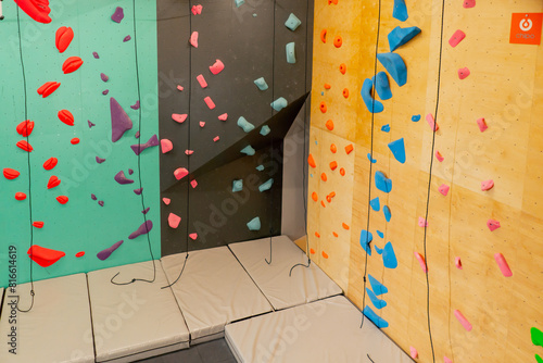 professional beautiful new climbing climber completely attached to training and training in different wall colors