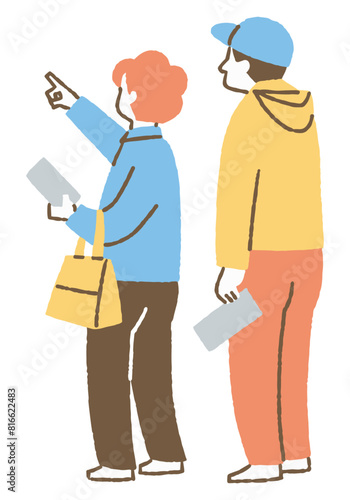 A couple pointing at a painting at an exhibition_Color