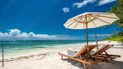 Two Lounge Chairs and Umbrella on Sandy Beach © Rene Grycner