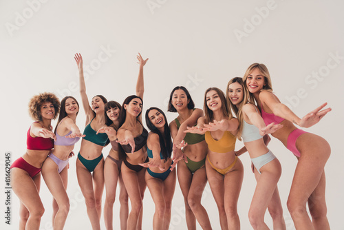 Photo of group ten women in lingerie keep you attention and would like touching isolated on white color background photo