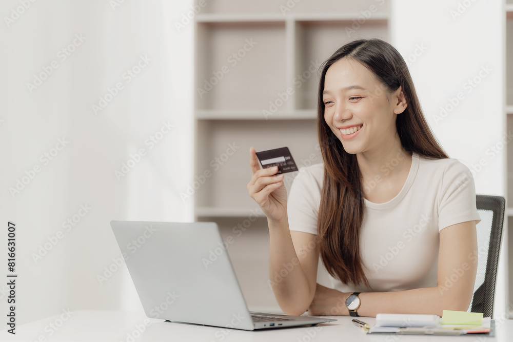Attractive Asian woman holds smartphone and credit card on her laptop using mobile banking or online shopping app
Payment via internet banking Attractive Asian woman holds smartphone and credit card on her laptop using mobile banking or online shopping app
Payment via internet banking