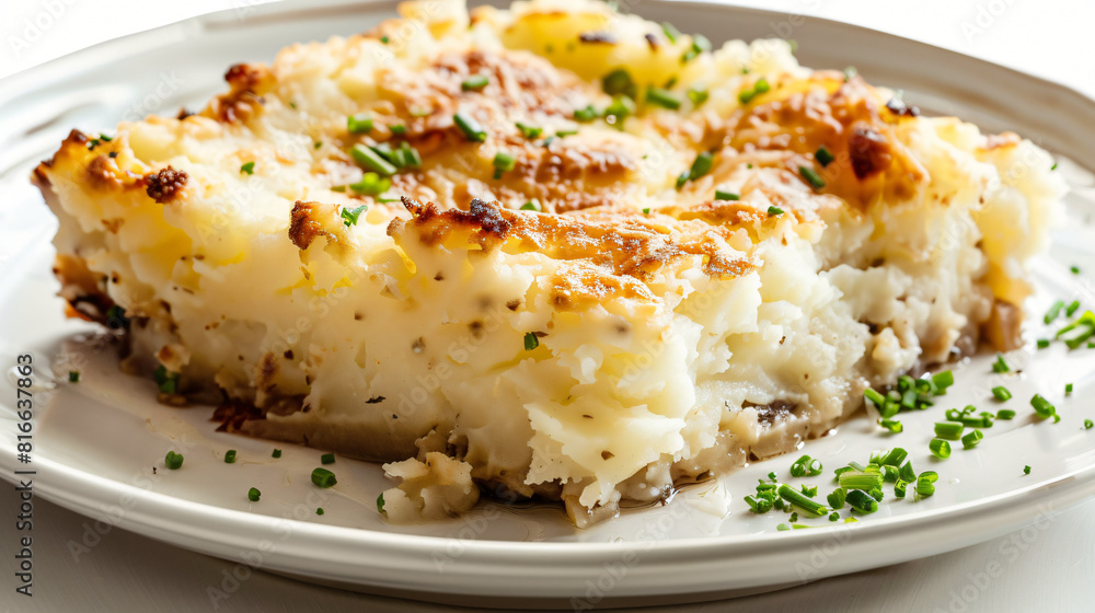 Plate with piece of mashed potato casserole on white b