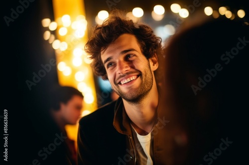 young smiling man with brown curls