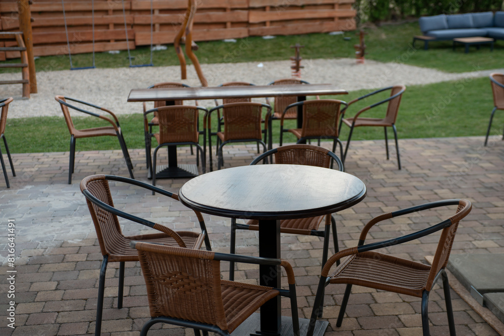 Obraz premium Outdoor coffee terrace with tables and chairs in a summer day