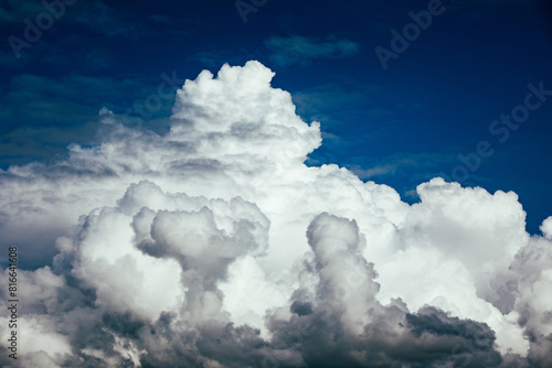 White puffy clouds against a dark blue contrasting sky