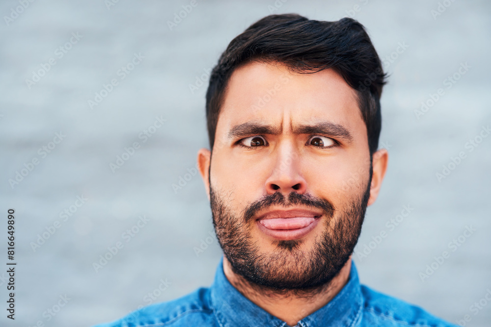 Comic, crossed eyes and man with tongue out, silly and portrait outside by brick wall. Male comedian, funny and making fun in city for humor, comedy and goofy personality and emoji reaction for fun Comic, crossed eyes and man with tongue out, silly and portrait outside by brick wall. Male comedian, funny and making fun in city for humor, comedy and goofy personality and emoji reaction for fun