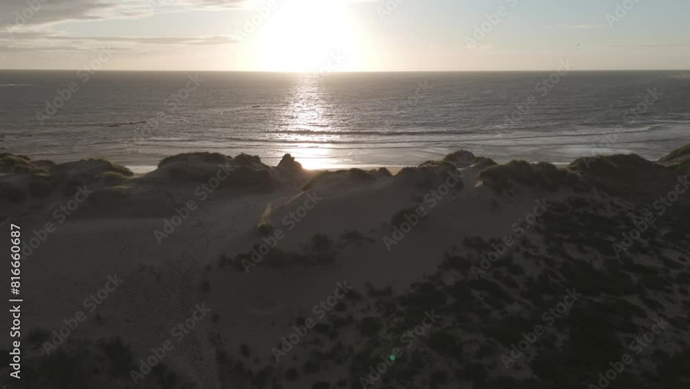 Aerial view of sand dunes and ocean at Ofir Beach in Esposende, Portugal during sunset. Aerial view of sand dunes and ocean at Ofir Beach in Esposende, Portugal during sunset.