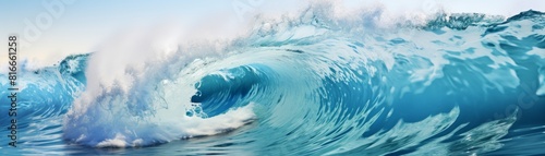 a large wave about to break on the shore. The wave is blue and green, and the water is white.