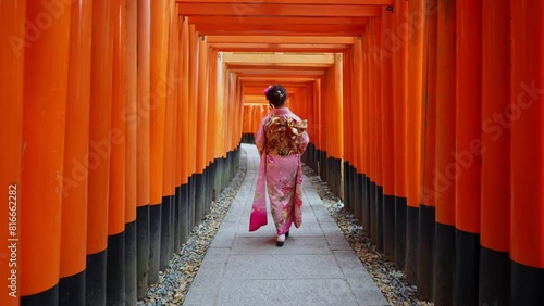 4k Slow motion video, Asian woman in traditional Japanese kimono at Fushimi Inari Shrine in Kyoto Japan.