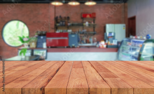perspective wooden board over blurred coffee shop