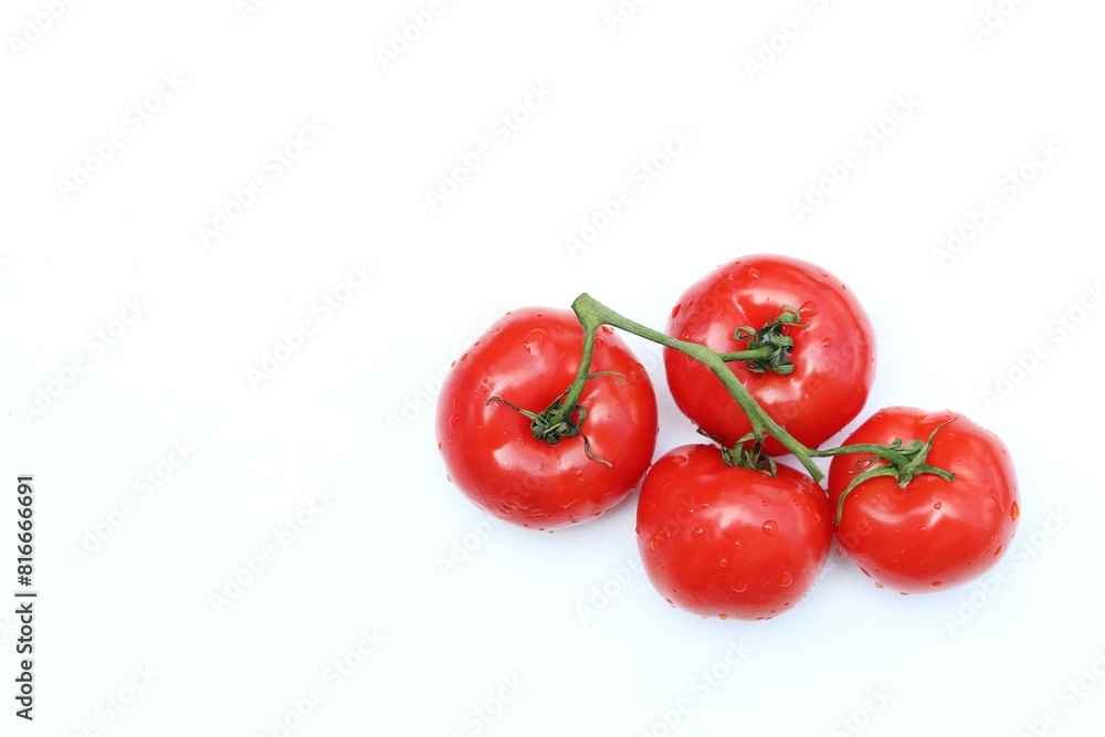 Branch of red tomatoes, tomato, on a white table, salad, vegetables, free space, place for text, top view, background Branch of red tomatoes, tomato, on a white table, salad, vegetables, free space, place for text, top view, background
