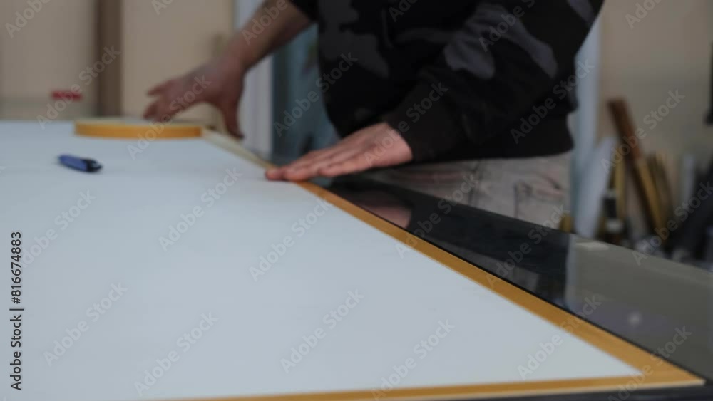 Person applying double sided tape. Person applying double sided tape.