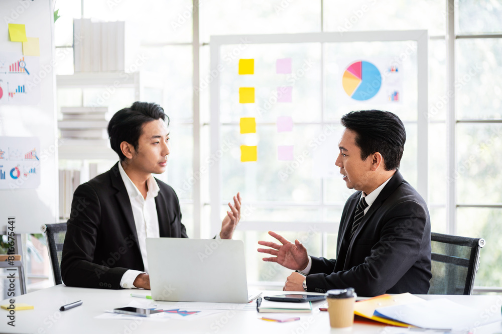Fototapeta premium Professional Asian business adviser meeting to analyze and discuss the strategy of financial support of a tech company. Partnership start-up consultant, Indoor business client consultation concept.