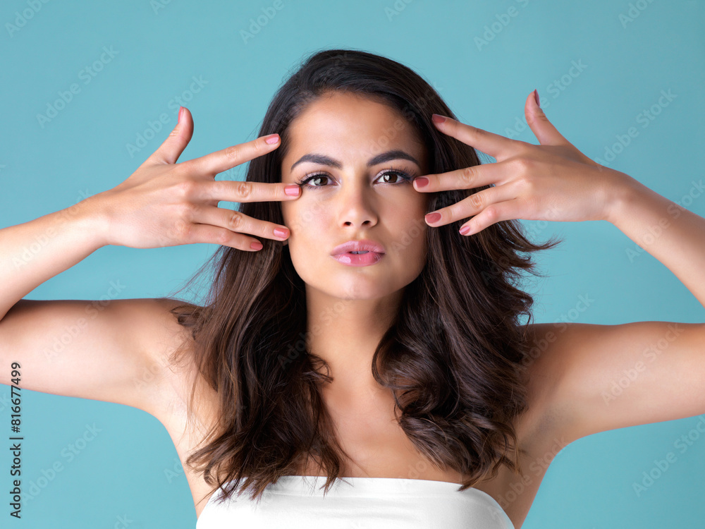 Obraz premium Woman, studio and portrait with manicure for beauty, cosmetics with red nail polish and lipstick. Female person, blue background and hands with treatment for makeup, gloss with shine in New York City
