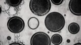 Black abstract background with white circle rings in faded distressed vintage grunge texture design