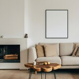 Mockup white poster frame on the wall. Wood slab coffee table, sofa with beige pillows near fireplace against white wall with copy space. Scandinavian home interior design of modern living room.