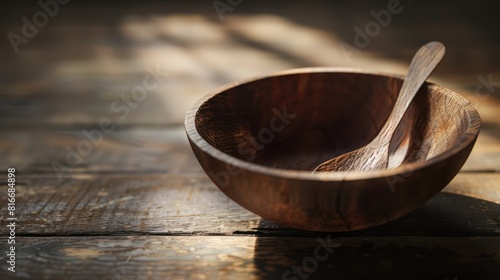 An empty wooden bowl with a spoon and a wooden bottom.