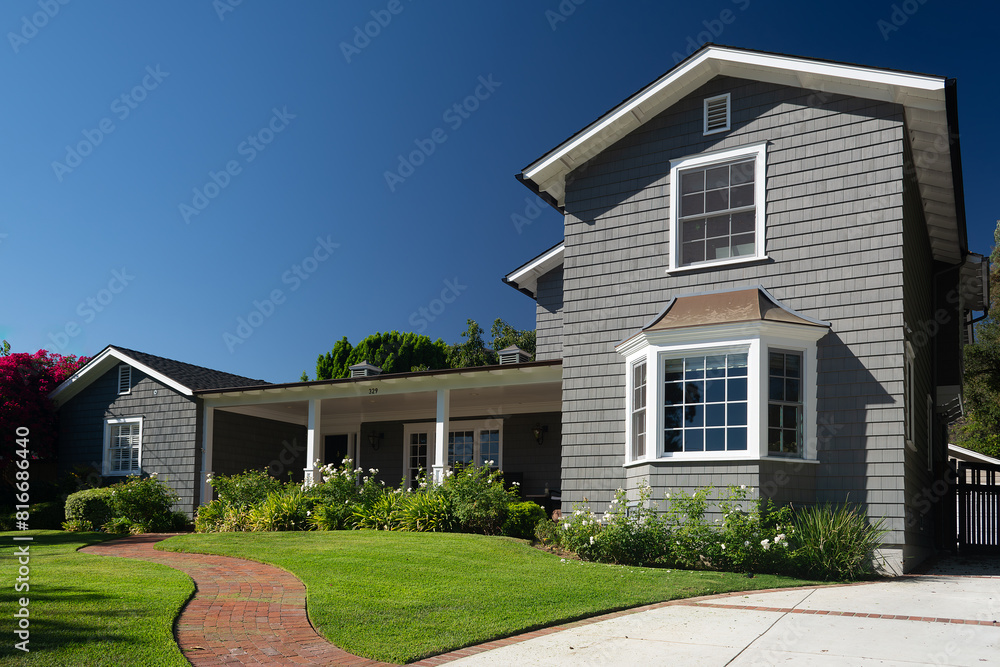 Classic American suburban house with a bright and vibrant flower garden in the front yard Classic American suburban house with a bright and vibrant flower garden in the front yard