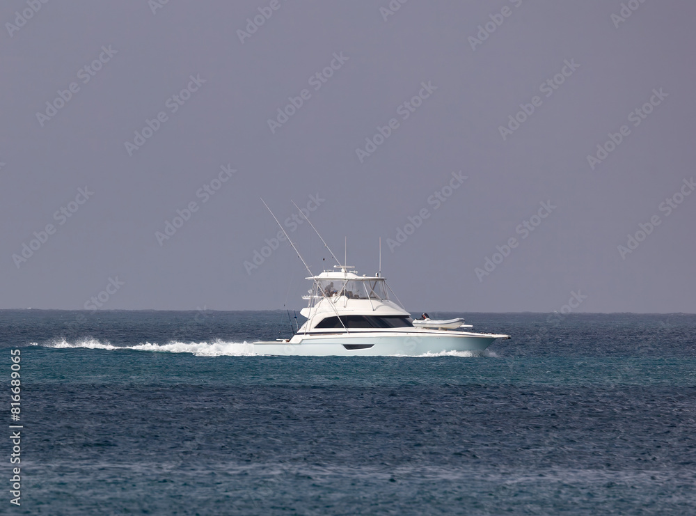 White boat drifting in a vast body of water. White boat drifting in a vast body of water.