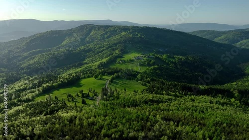 Aerial shot of Beskid Zywiecki with vibrant green forest and meadows in springtime  photo