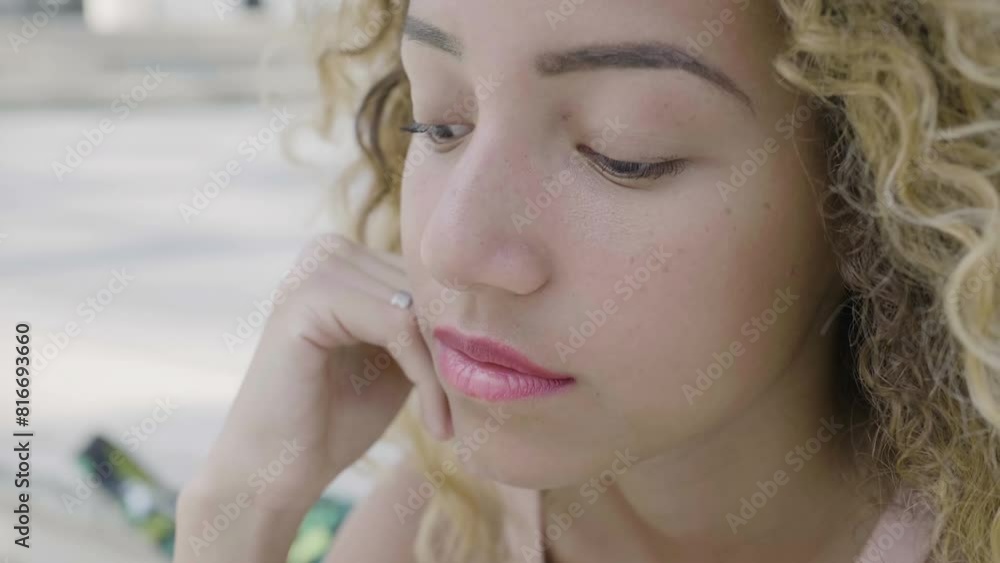 pensive woman starting smiling sitting alone in the city pensive woman starting smiling sitting alone in the city