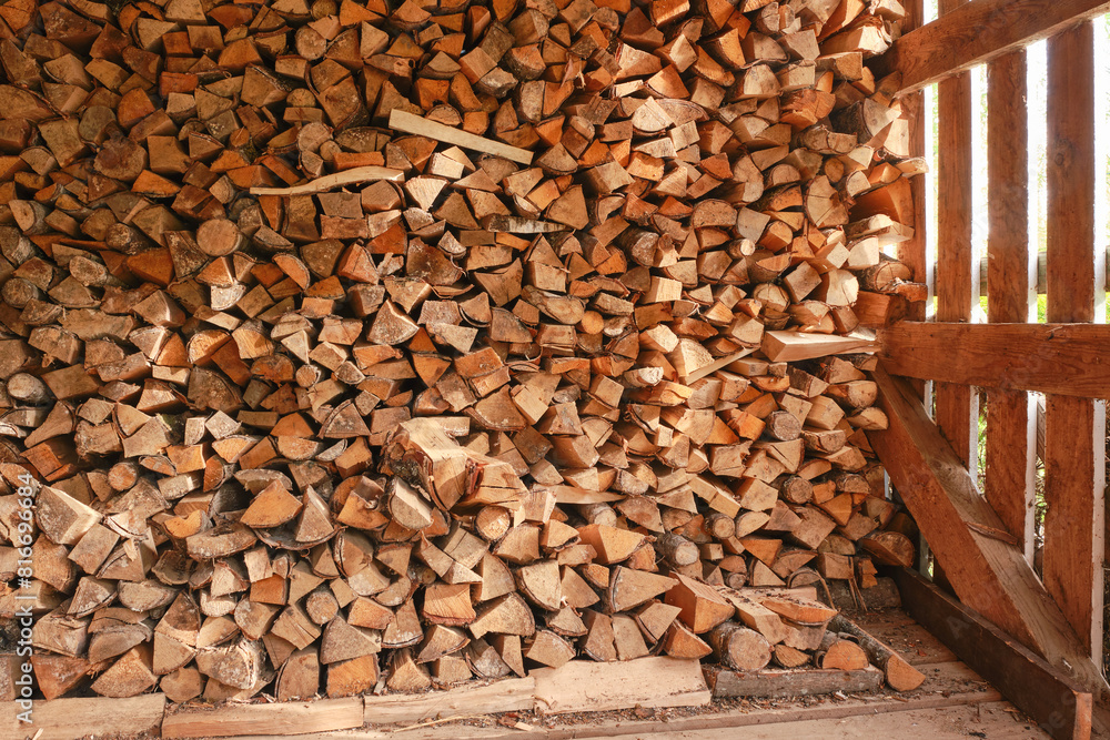 Wooden shed for storing firewood. Firewood pile. Birch firewood are neatly stacked. Selective focus Wooden shed for storing firewood. Firewood pile. Birch firewood are neatly stacked. Selective focus
