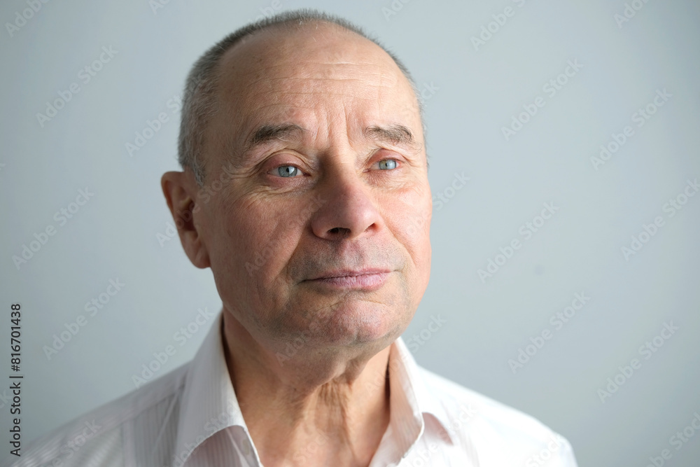 Fototapeta premium close-up of mature charismatic man, senior 60 years look thoughtfully to the side, rejoices at news, wrinkles on face, overhang, concept human health, good mood, optimism, , midlife crisis