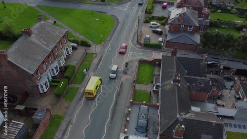 Drone 50fps. Emergency. UK ambulance responder on a street, busy road. 
