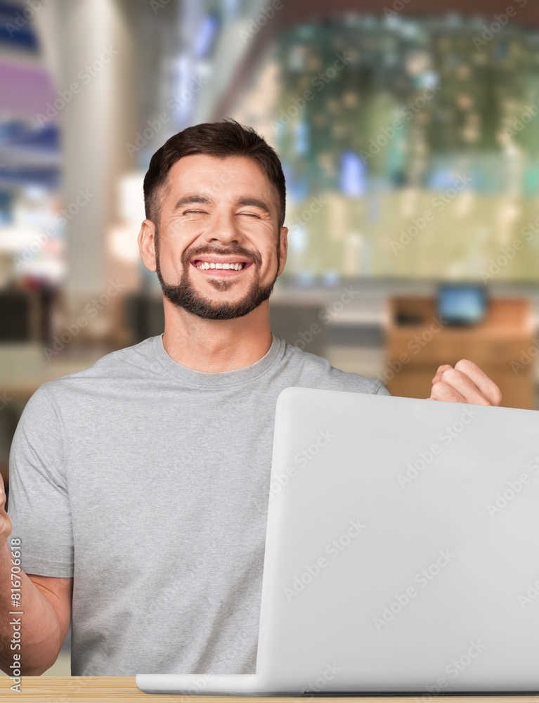 Fototapeta premium Happy young business man using laptop computer