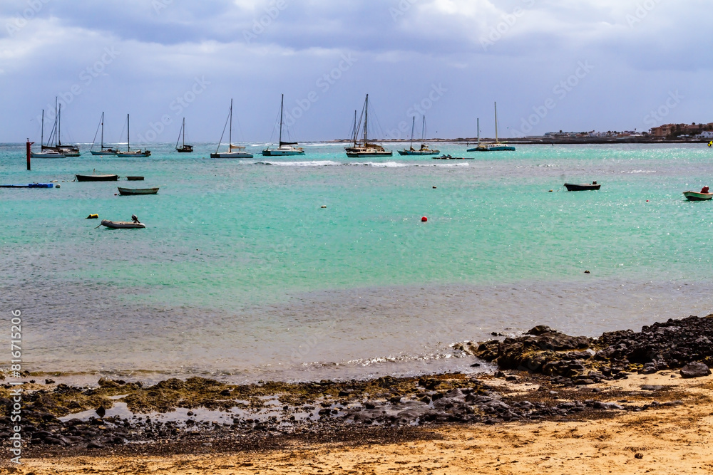 Obraz premium Sailboats and boats moored in Corralejo harbour. Fuerteventura, Canary Islands, Spain