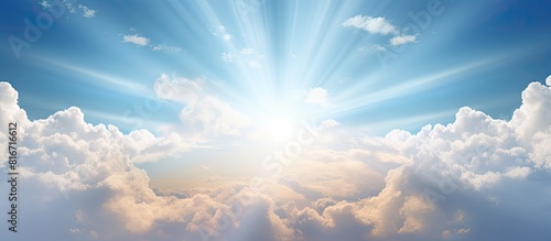The sun shines brightly as it emerges from the cover of the clouds in the sky creating a beautiful copy space image