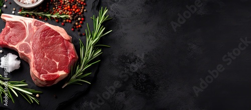 Top view of an uncooked lamb chop steak and mutton cutlet on a marble board against a black background Perfect for copy space image photo