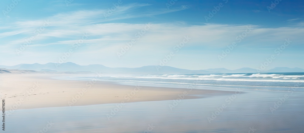A serene empty beach emerges as the tide recedes offering a perfect backdrop for a copy space image