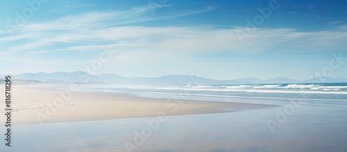 A serene empty beach emerges as the tide recedes offering a perfect backdrop for a copy space image