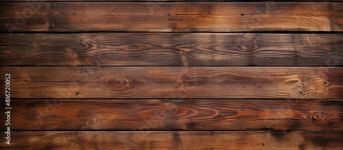 Copy space image of a vintage brown wooden background with visible knots and nail holes resembling an old painted wood wall The horizontal dark boards create an abstract and vintage atmosphere Perfec