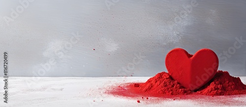 A copy space image of red heart shaped confectionery powder on a background of gray concrete perfect for Valentine s Day