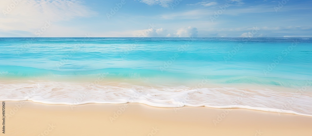 A tropical beach with colorful sand and crystal clear waves creates a stunning natural background perfect for a copy space image