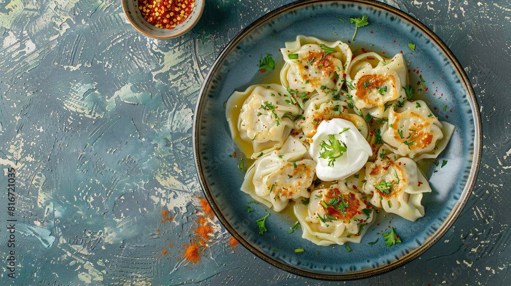 Plate with tasty dumplings and sour cream on grunge background