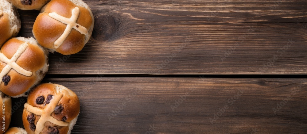 A copy space image shows traditional Easter hot cross buns from a top view on a wooden background A copy space image shows traditional Easter hot cross buns from a top view on a wooden background