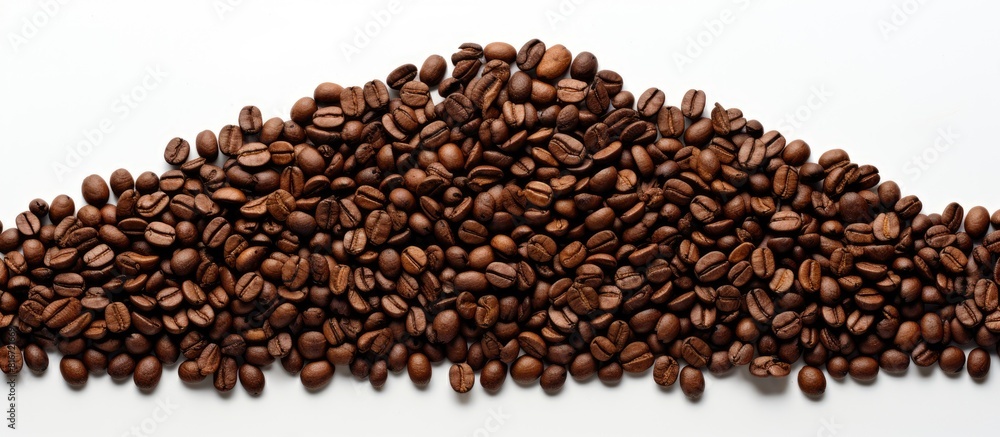 A copy space image of brown coffee beans arranged in the shape of a Christmas tree on a white background A copy space image of brown coffee beans arranged in the shape of a Christmas tree on a white background