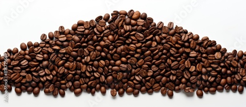 A copy space image of brown coffee beans arranged in the shape of a Christmas tree on a white background