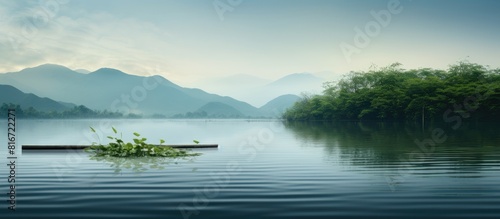 A serene creek reservoir scene with a bamboo raft floating peacefully through the water offering ample copy space for images