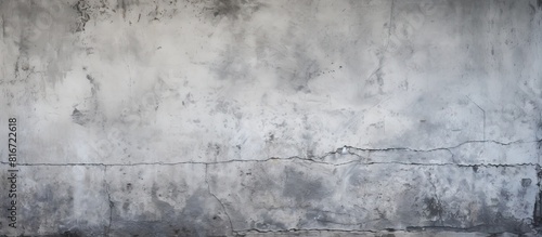 The background showcases the texture of an aged gray concrete wall providing ample copy space for images