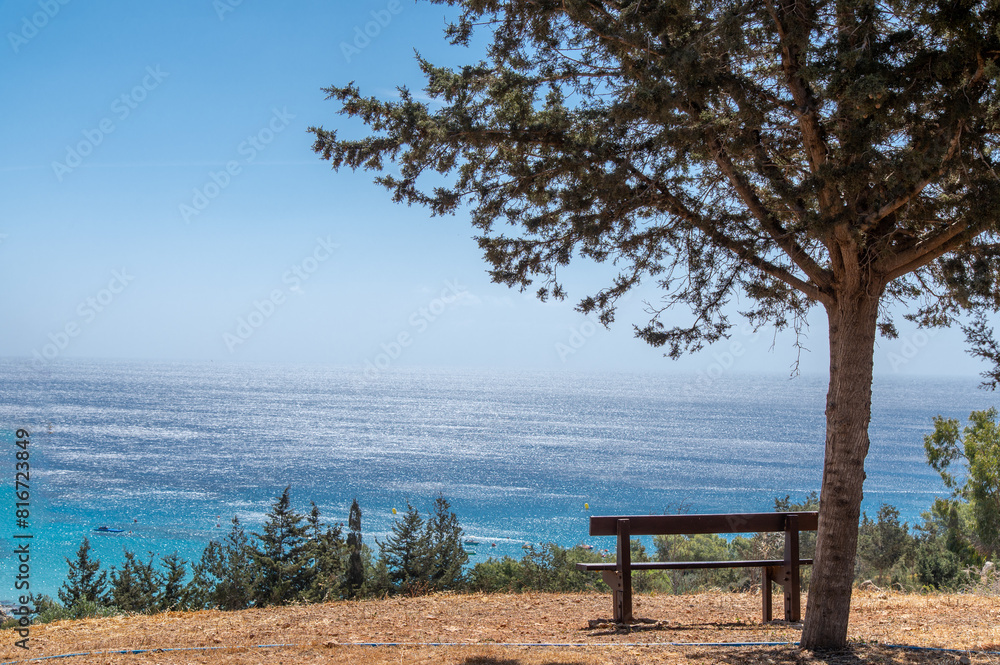 A bench with a view to the sea in Cape Greco National Park on Cyprus A bench with a view to the sea in Cape Greco National Park on Cyprus