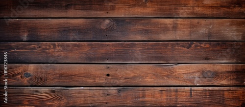Copy space image of a vintage brown wooden background with visible knots and nail holes resembling an old painted wood wall The horizontal dark boards create an abstract and vintage atmosphere Perfec photo