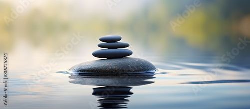 The Zen stone is a representation of both balance and meditation with a serene and harmonious presence It can be used as a focal point for relaxation and mindfulness practices. with copy space image